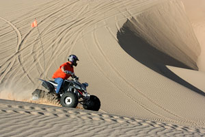 quad atv rider - sand dunes